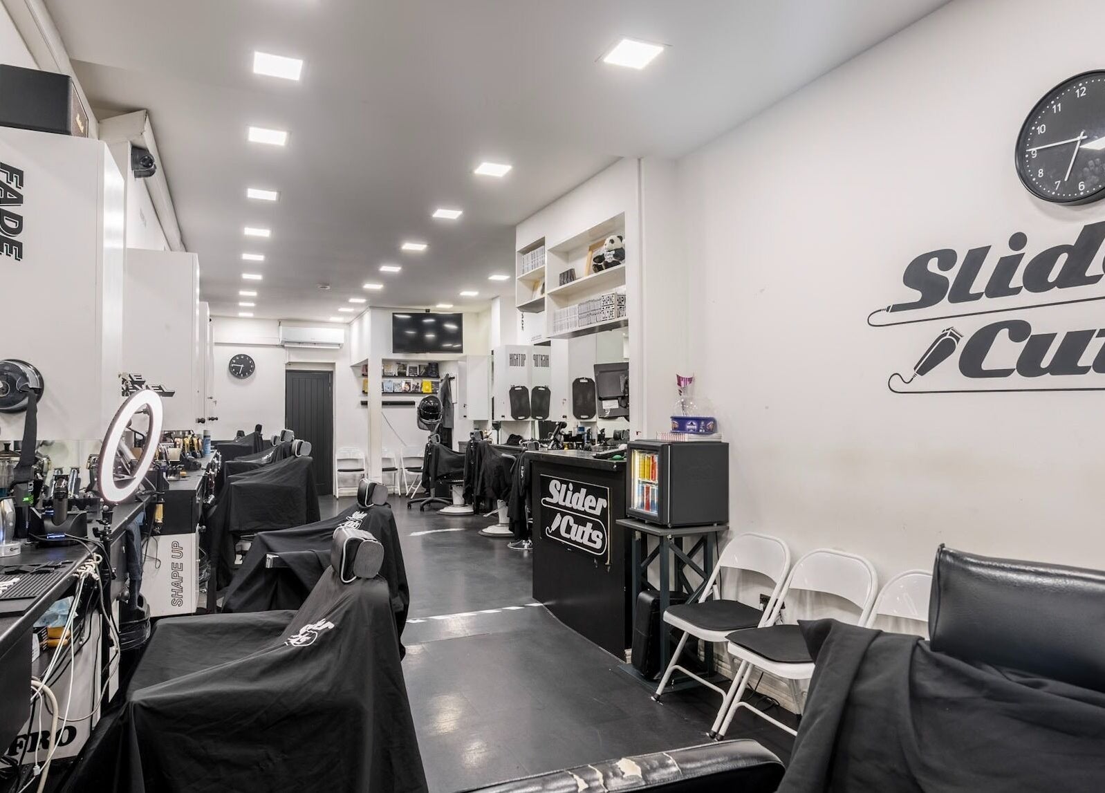 Interior of SliderCuts barber shop in London, England, GB with stylish chairs and modern decor.