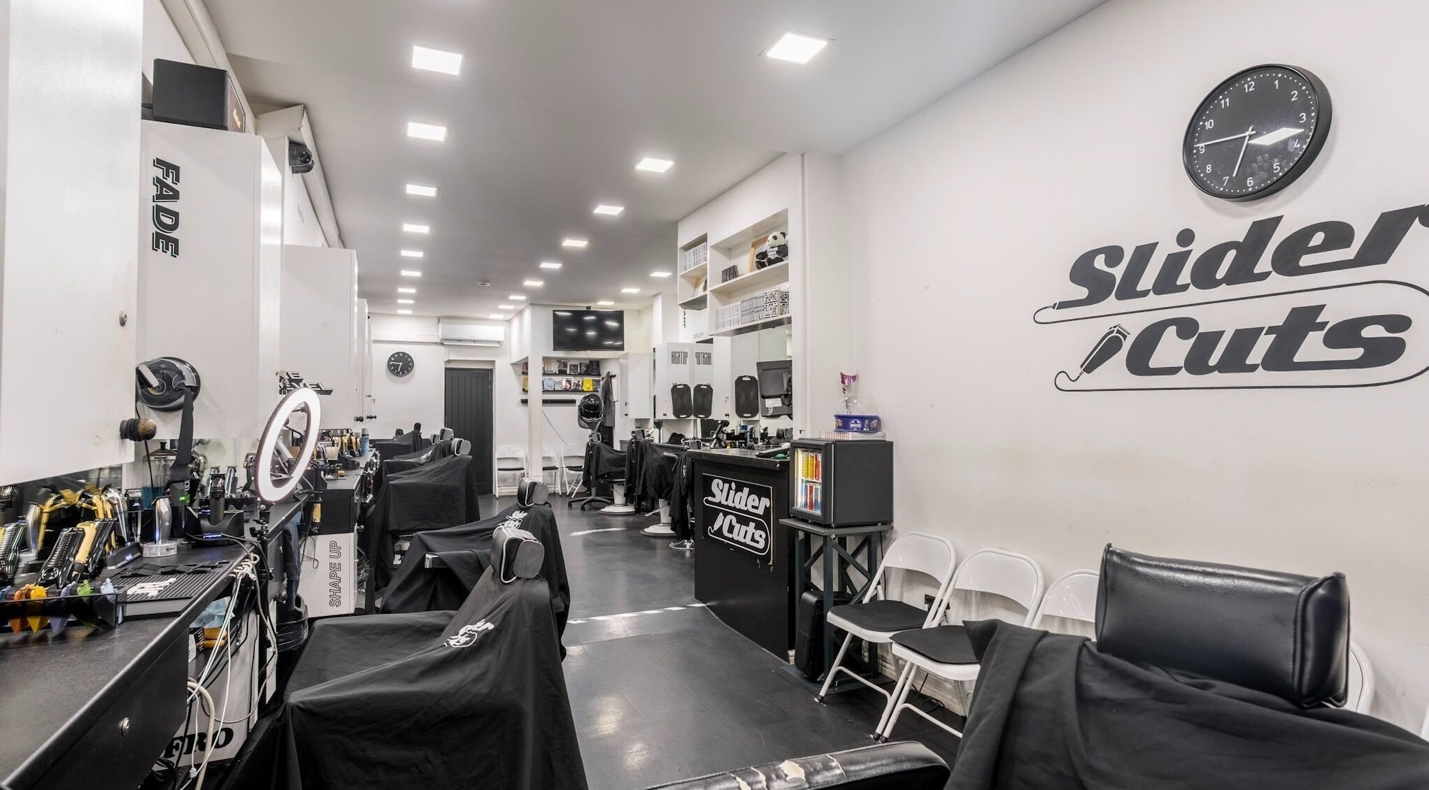 Interior of SliderCuts barber shop in London, England, GB with stylish chairs and modern decor.