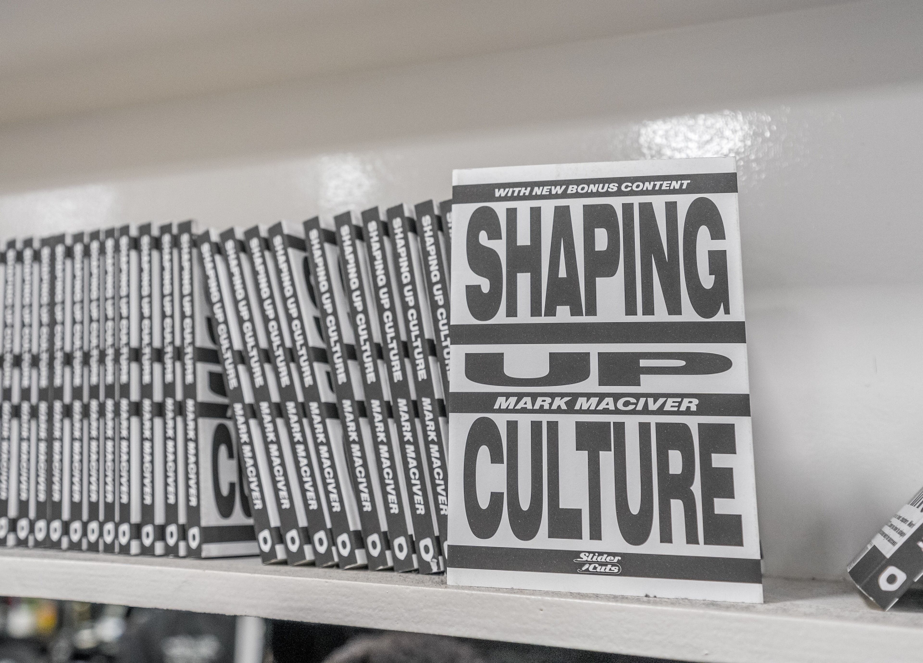 Stack of 'Shaping Up Culture' books by Mark Maciver at SliderCuts, London, England, GB.