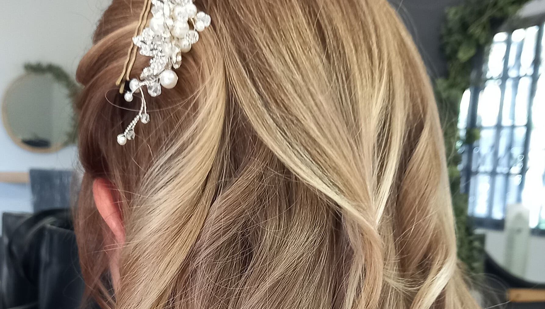 Elegant updo with pearl accessory at Purple Hair in Sandton, Gauteng, ZA.