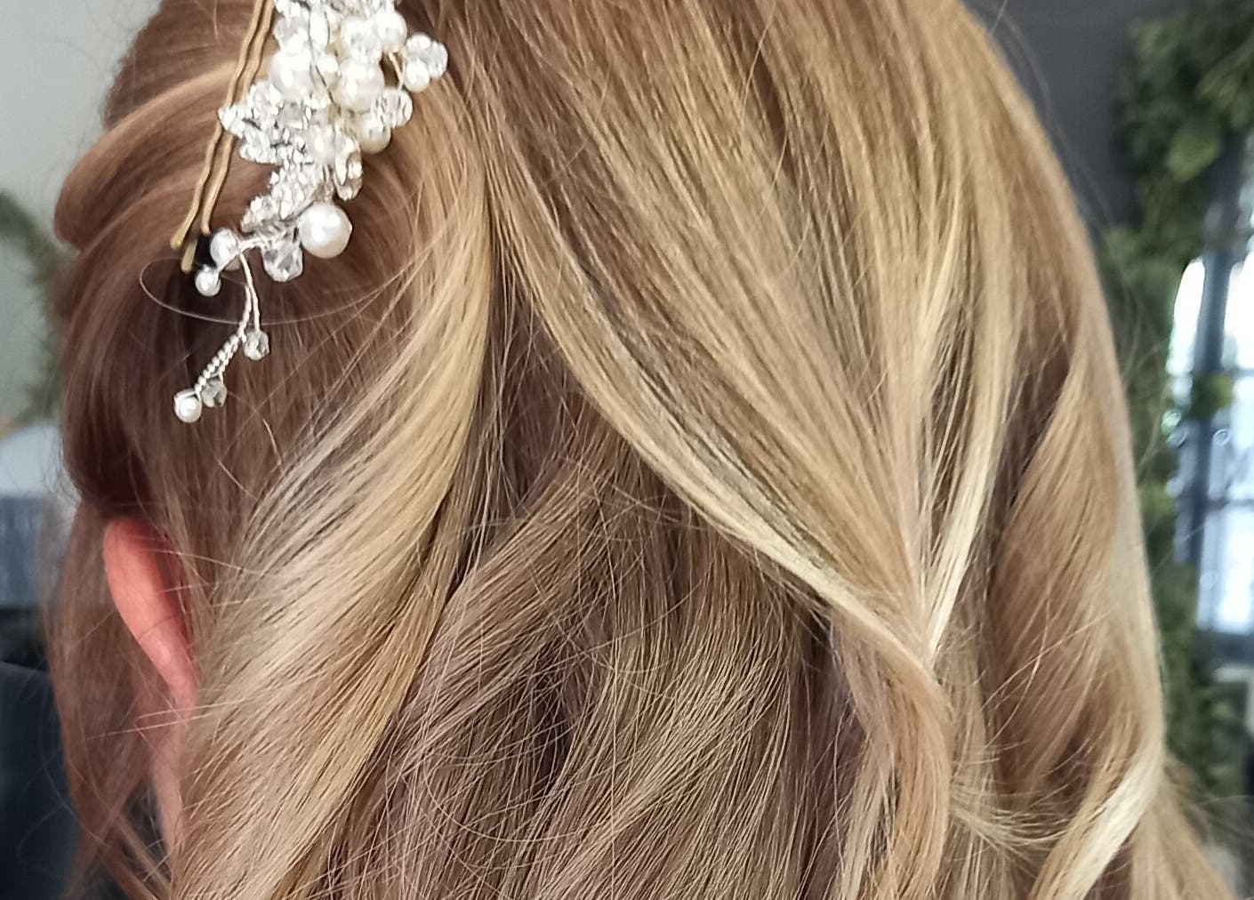 Elegant updo with pearl accessory at Purple Hair in Sandton, Gauteng, ZA.