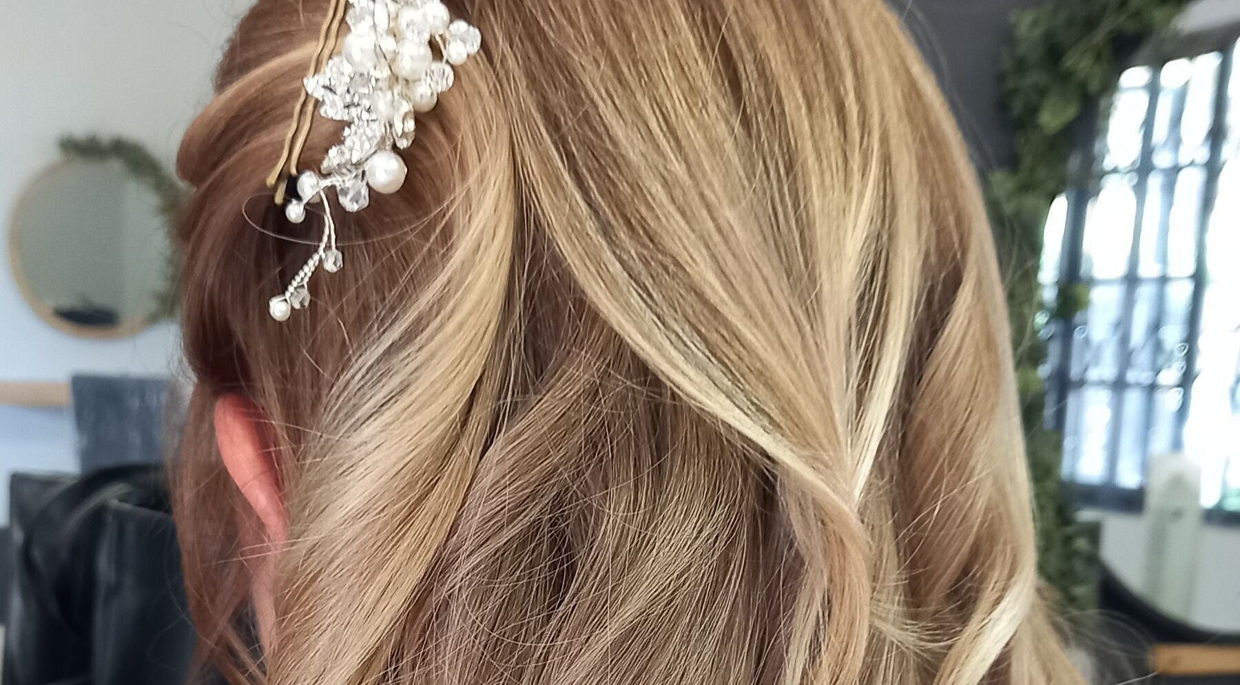 Elegant updo with pearl accessory at Purple Hair in Sandton, Gauteng, ZA.