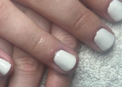 Elegant white manicured nails showcased at Tashie’s Beauty Pod, Warfield, England, GB.