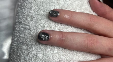 Stylish black and glitter nail art at Tashie’s Beauty Pod in Warfield, England, GB.