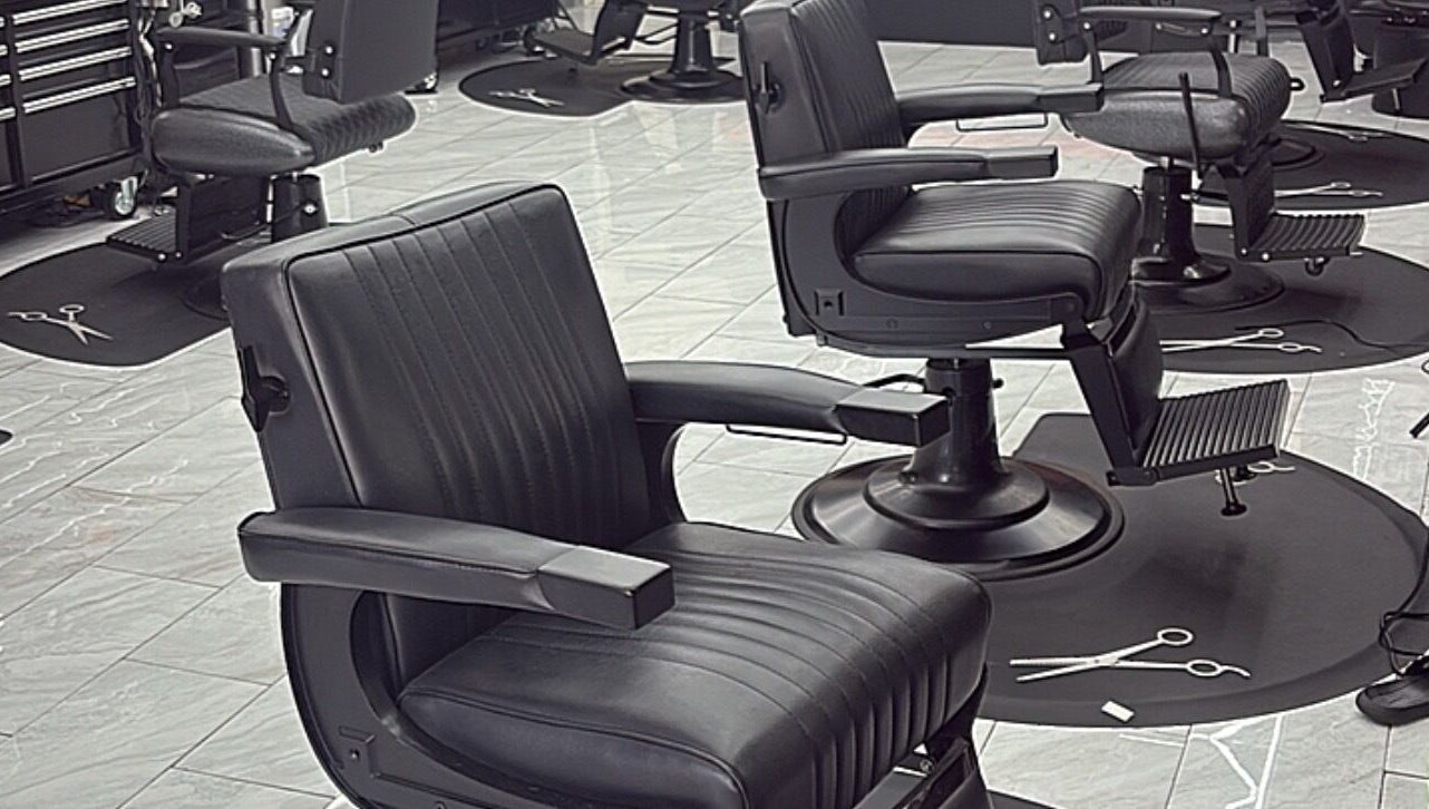 Modern black barber chairs at Another Level Barbershop in Baldwin, New York, US.