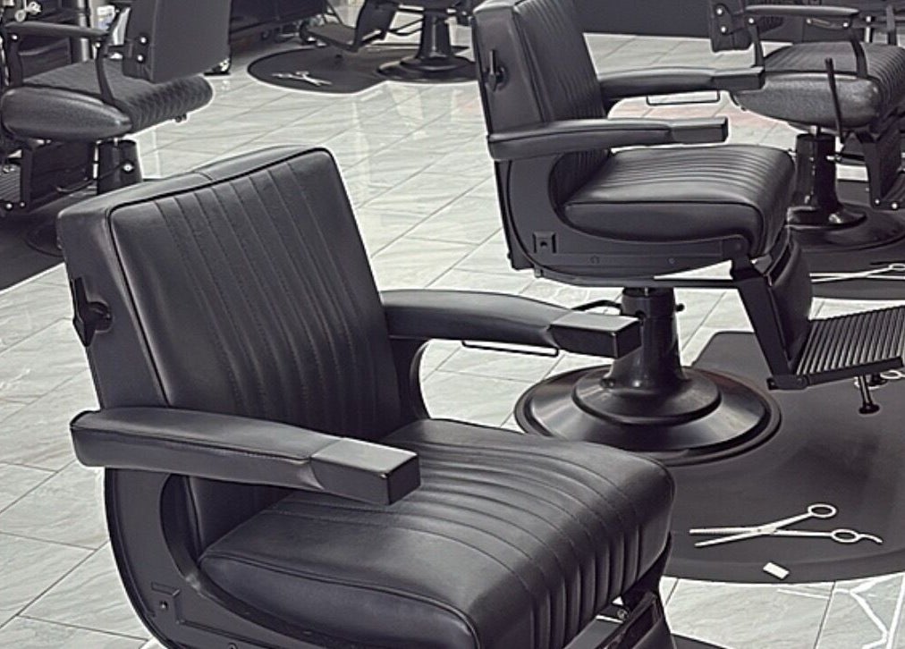 Modern black barber chairs at Another Level Barbershop in Baldwin, New York, US.