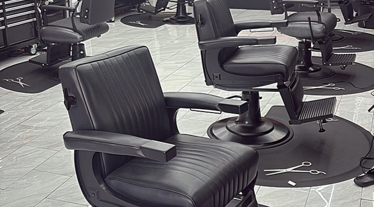 Modern black barber chairs at Another Level Barbershop in Baldwin, New York, US.