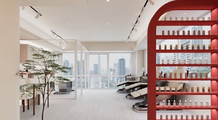 Modern spa interior at Nica Beauty, Hong Kong Island, featuring plush chairs and city views through large windows.