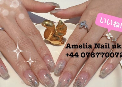 Stylish glitter manicure with elegant rings at Amelia Beauty, Manchester, England, GB.