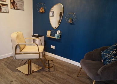 Stylish salon interior at Aura10, Long Hanborough, GB with a modern chair and elegant decor.