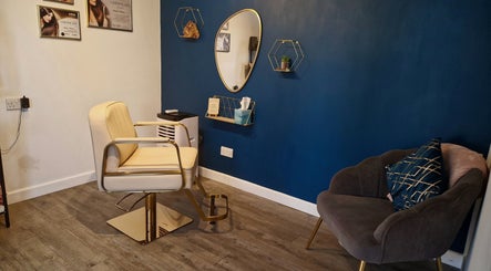 Stylish salon interior at Aura10, Long Hanborough, GB with a modern chair and elegant decor.