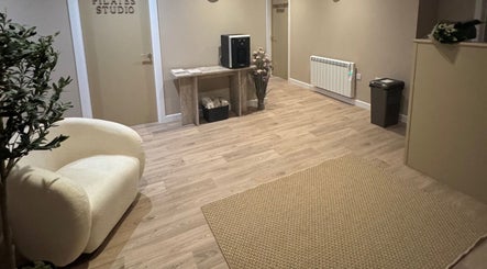 Welcoming foyer with soft chair and Pilates studio door at Revival Wellbeing, Thurso, Scotland, GB.