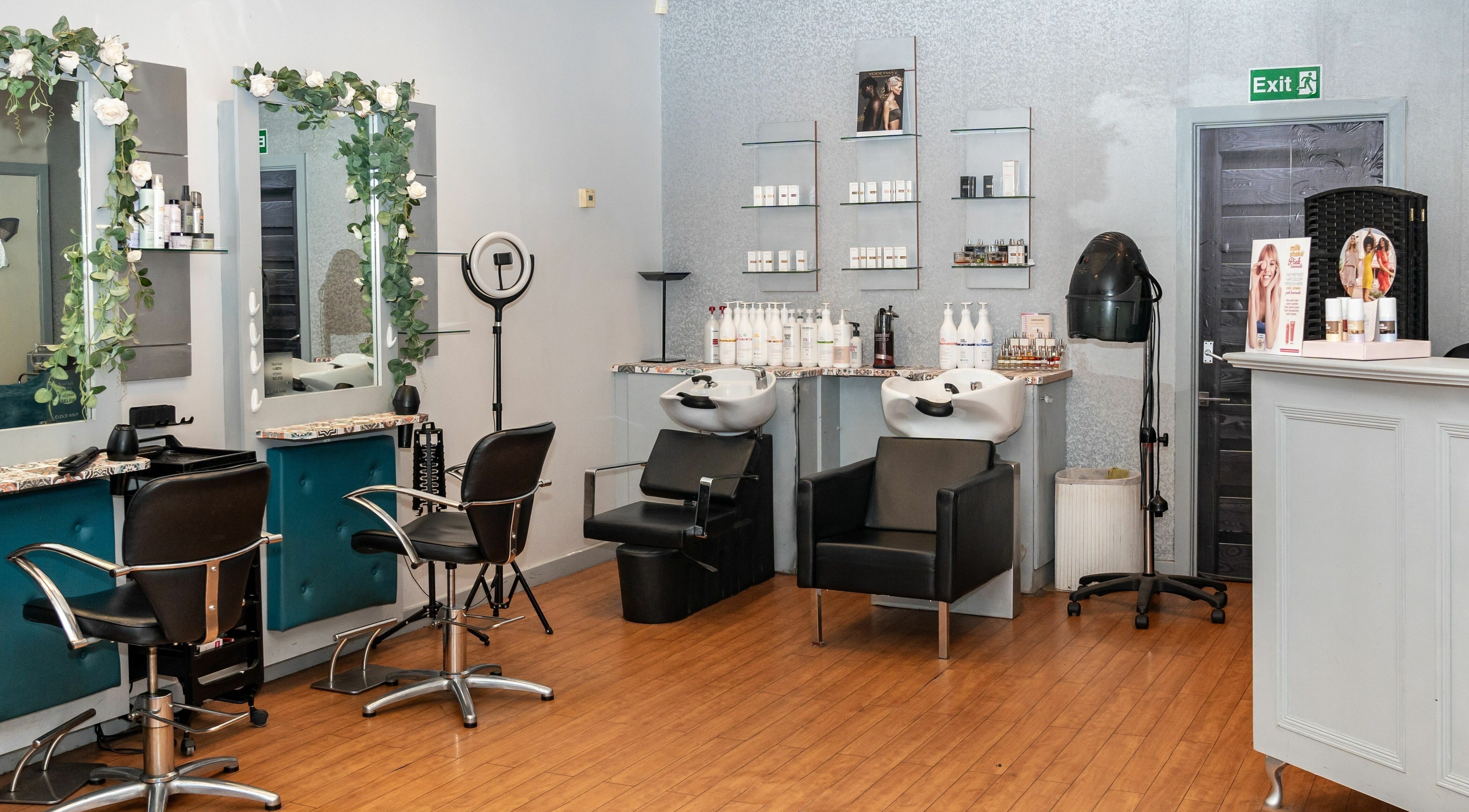 Modern hair salon interior at Elite Hair Studio (Leeds), Leeds, England, GB, featuring stylish stations and products.
