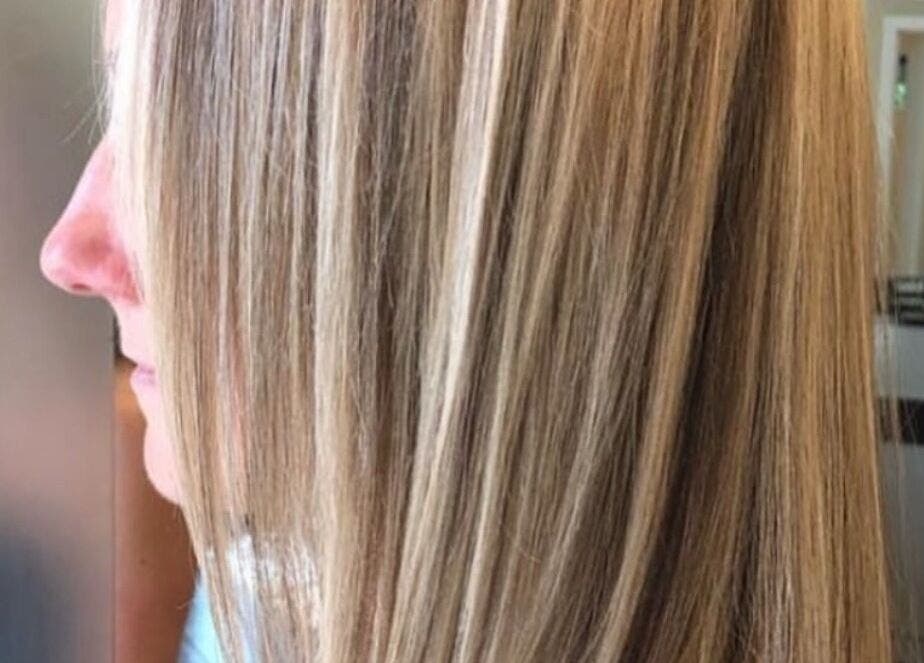 Smooth, sleek blonde hair styled at Holly Fitzgibbon in Boca Raton, Florida, US salon.