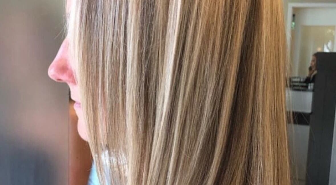 Smooth, sleek blonde hair styled at Holly Fitzgibbon in Boca Raton, Florida, US salon.