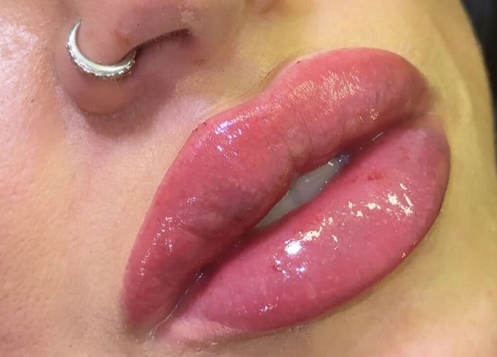 Shiny, plump lips with nose piercing at Skin & Beauty By Ells, Luton, England, GB.