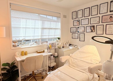 Interior of Skin Spa Home Beauty Studio in Collaroy Plateau, New South Wales, AU, featuring treatment bed and certificates.
