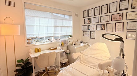 Interior of Skin Spa Home Beauty Studio in Collaroy Plateau, New South Wales, AU, featuring treatment bed and certificates.