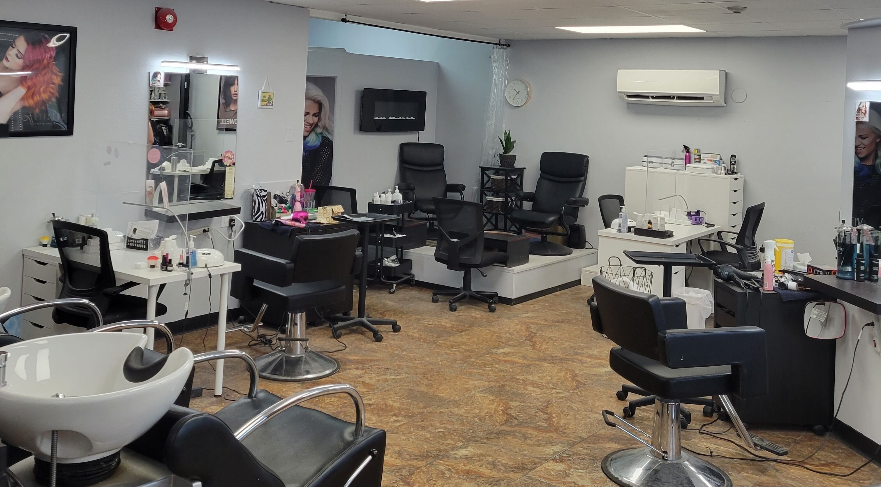 Interior of Artistry Salon in Brandon, Manitoba, CA showcasing stylish chairs and beauty stations.