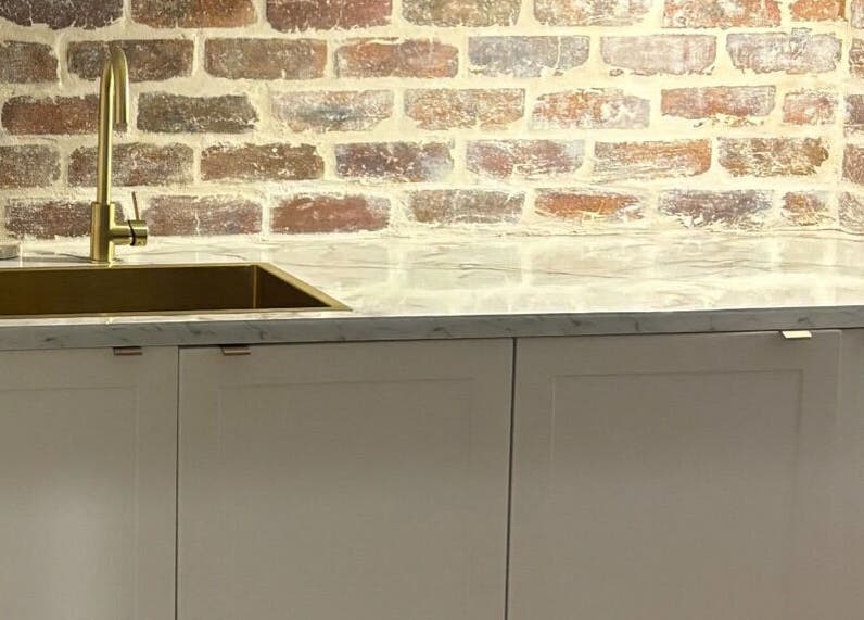 Elegant brick and marble sink area at The Lash Edit, Merrimac, Queensland, AU for a luxurious ambiance.