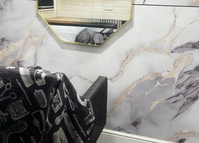 Glambysam_x salon interior with marble wall and mirror in Glasgow, Scotland, GB.
