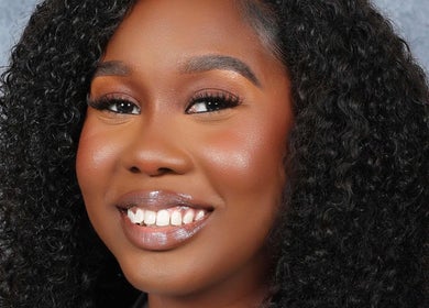 Close-up of a smiling woman at Beauty Refinery by Lia, Kingston 20, Kingston, JM.