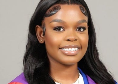Smiling woman with styled hair at Beauty Refinery by Lia, Kingston 20, Kingston, JM.