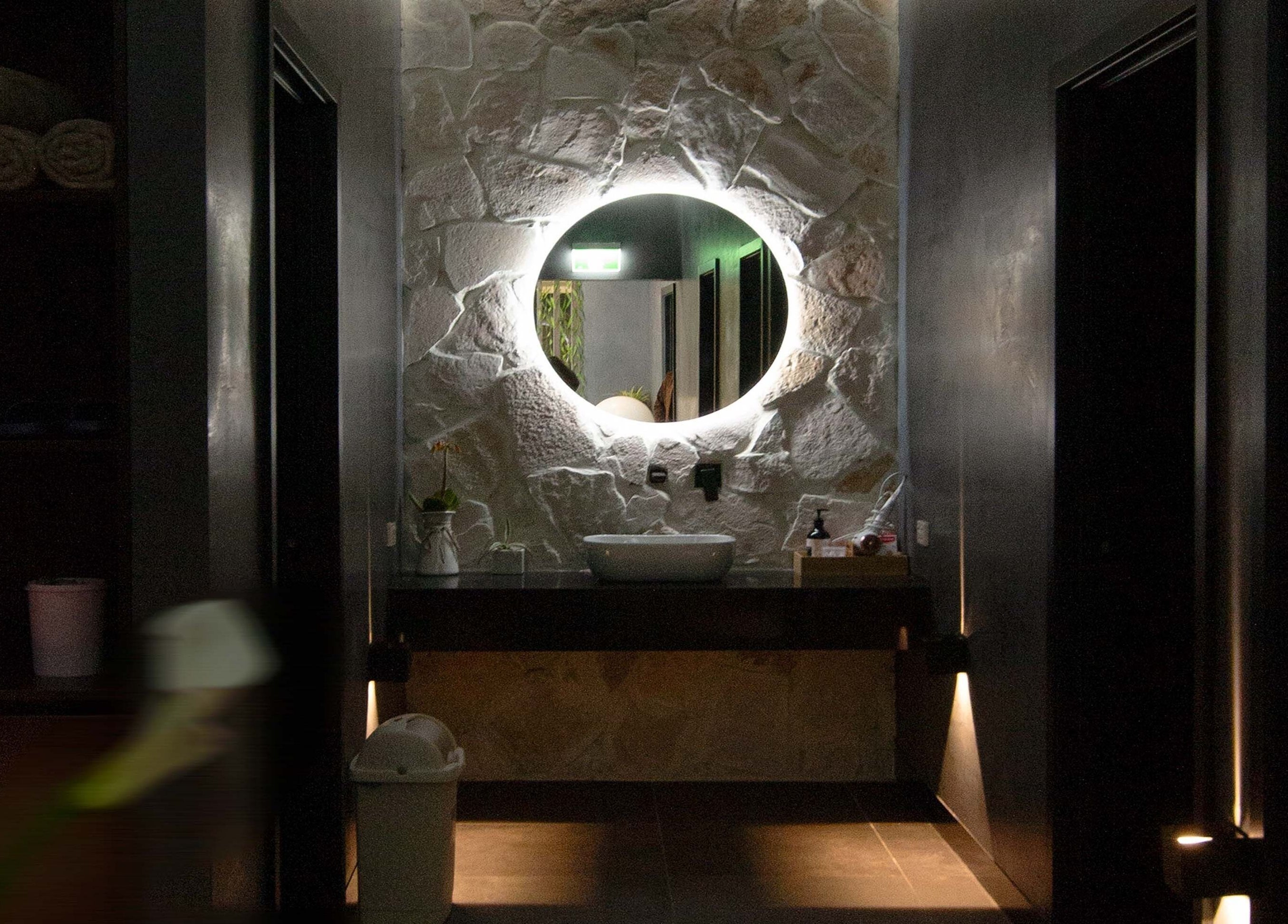 Chic stone wall with illuminated mirror at Innerverse Float & Wellness Oakleigh, Melbourne, Victoria, AU.