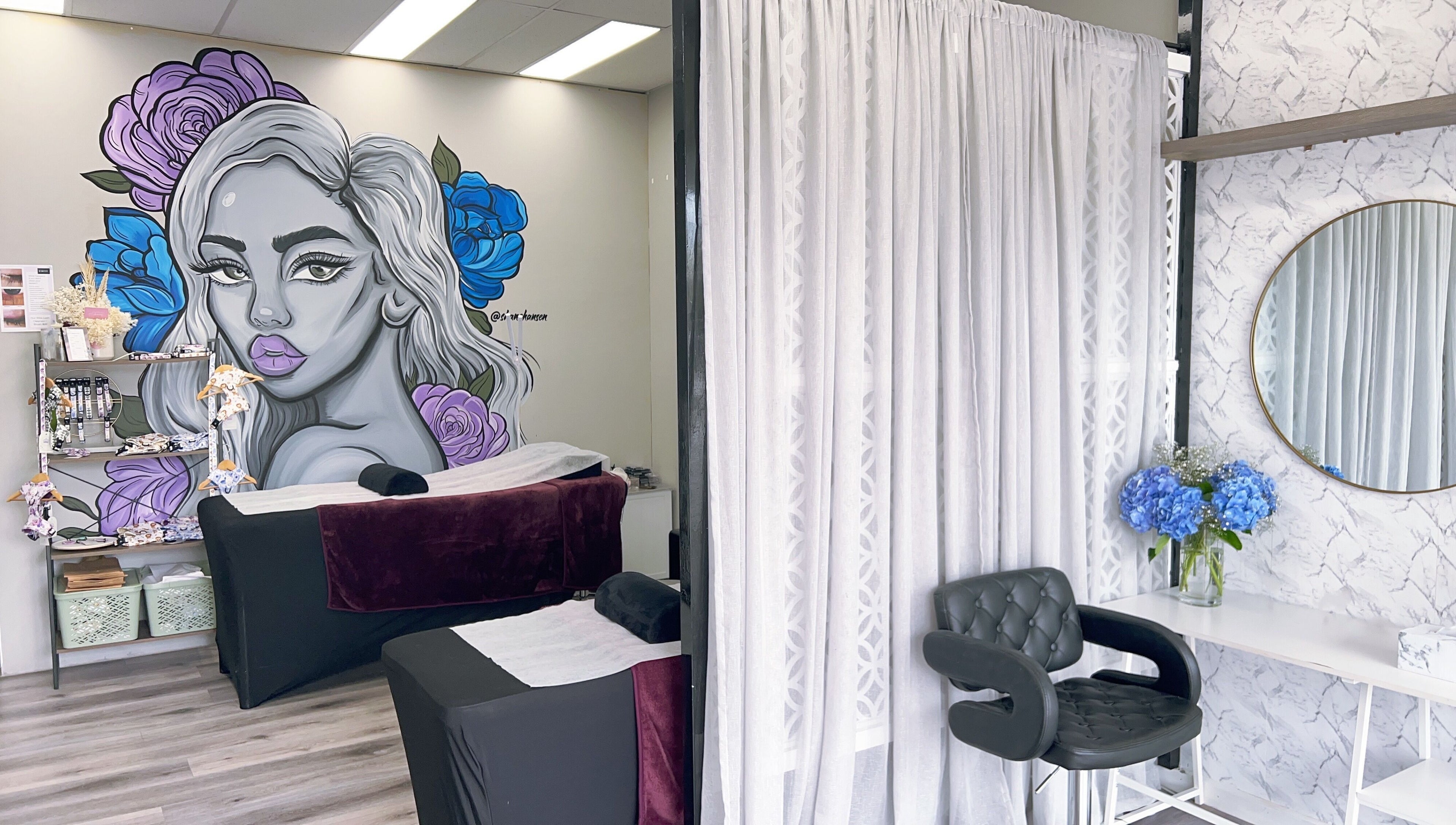 Relaxing treatment area at Bliss Lashes and Brows in Melbourne, Victoria, AU, featuring colorful wall art.