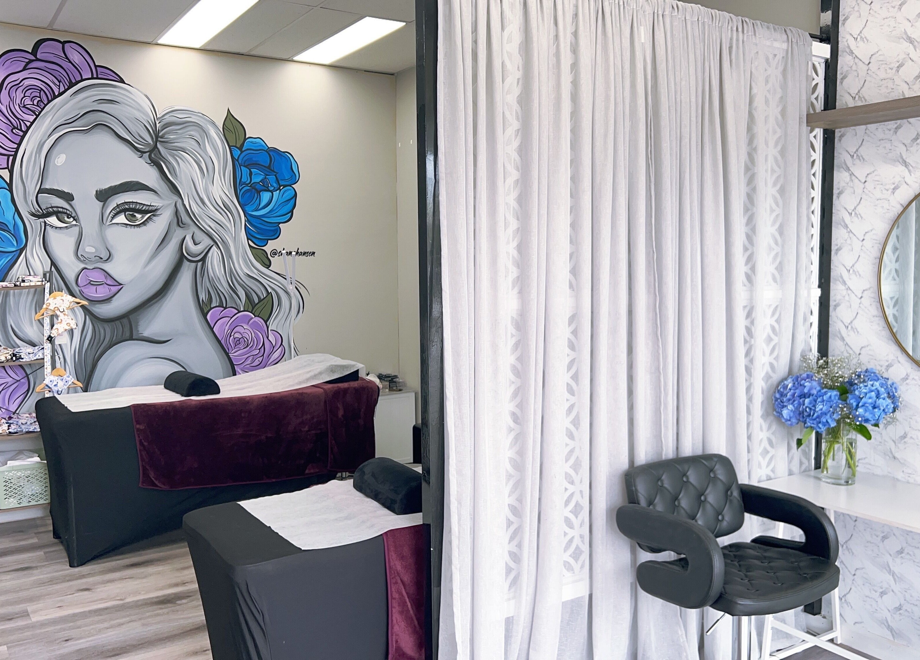Relaxing treatment area at Bliss Lashes and Brows in Melbourne, Victoria, AU, featuring colorful wall art.