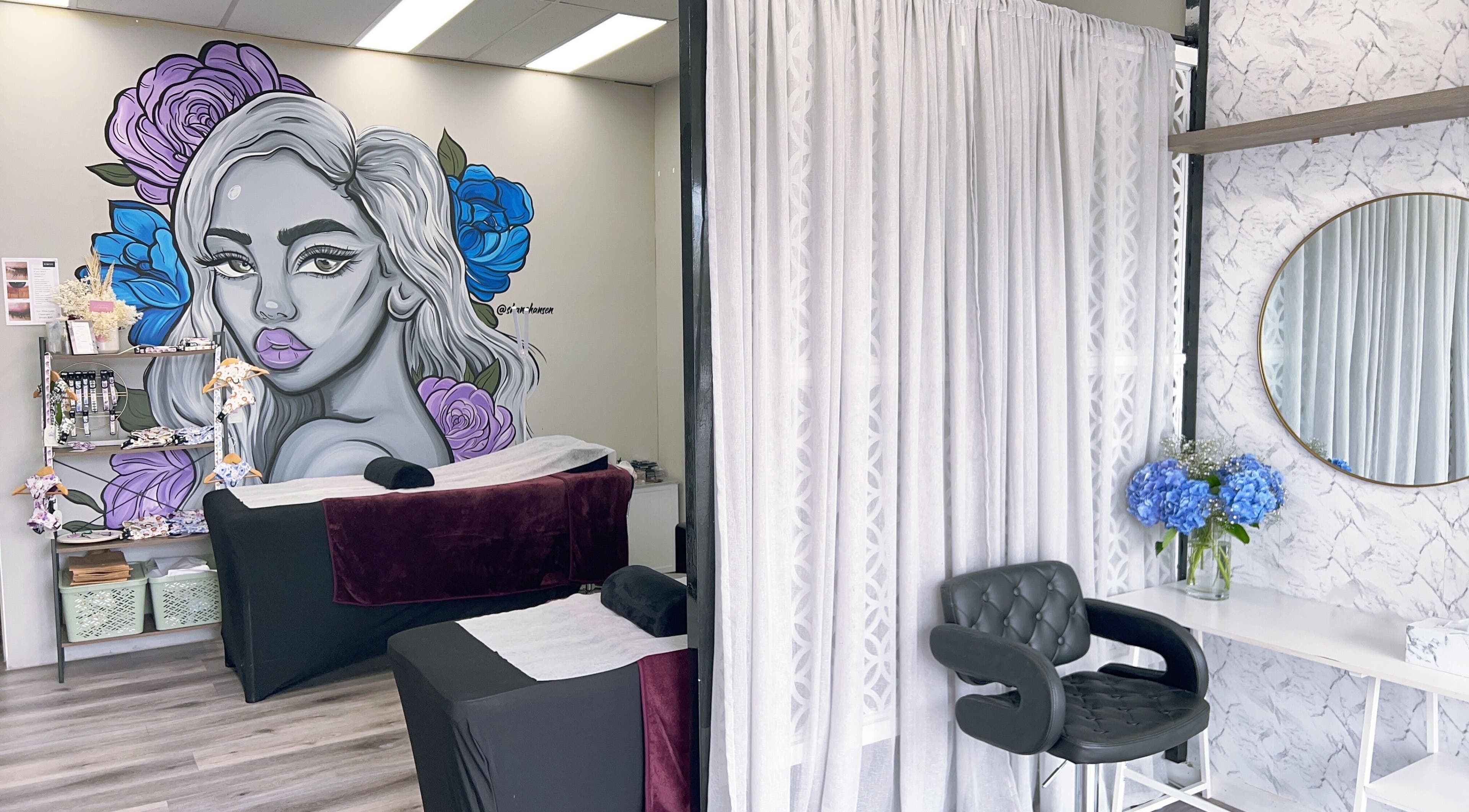 Relaxing treatment area at Bliss Lashes and Brows in Melbourne, Victoria, AU, featuring colorful wall art.