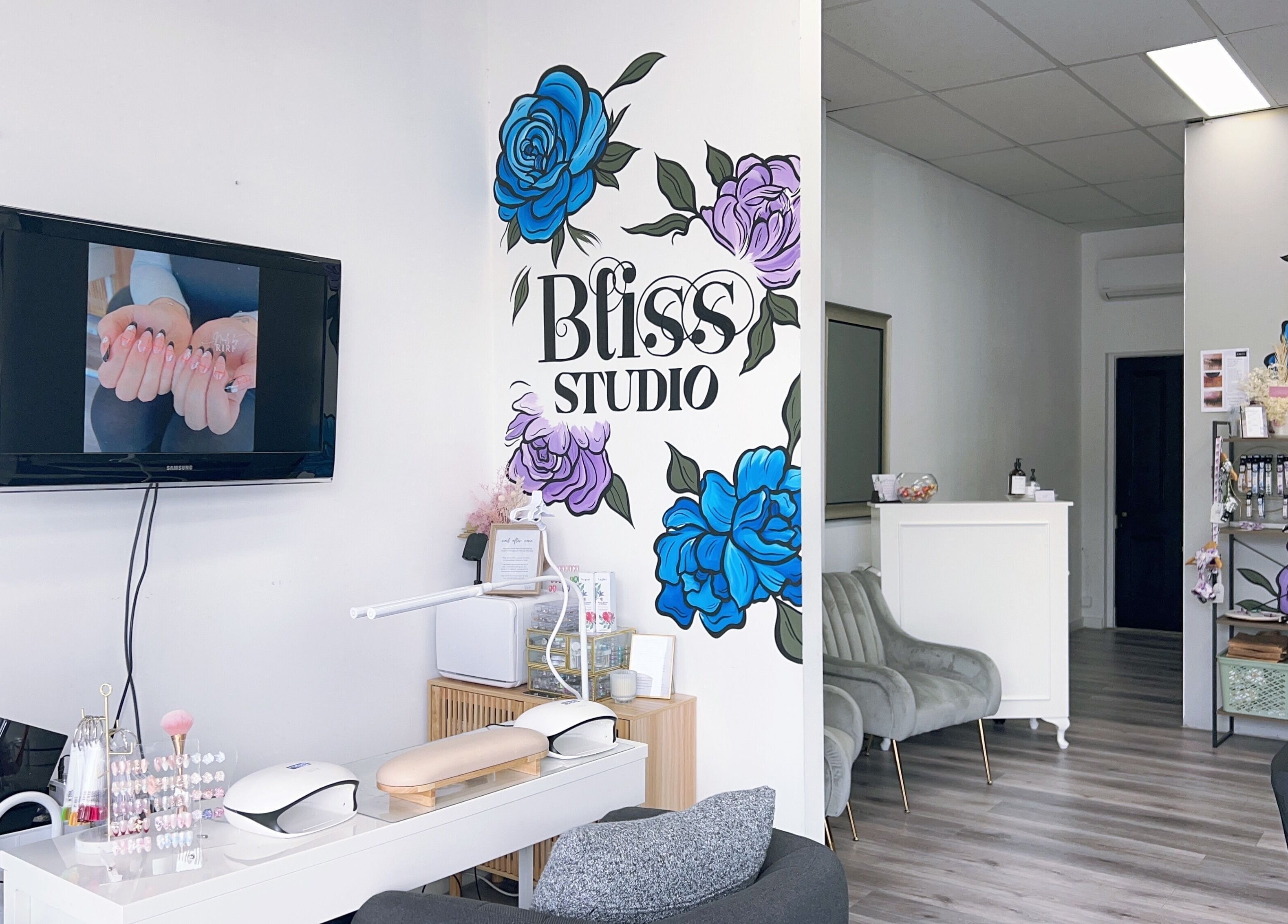 Interior of Bliss Lashes and Brows, Melbourne, Victoria, AU, featuring modern decor and floral wall art.
