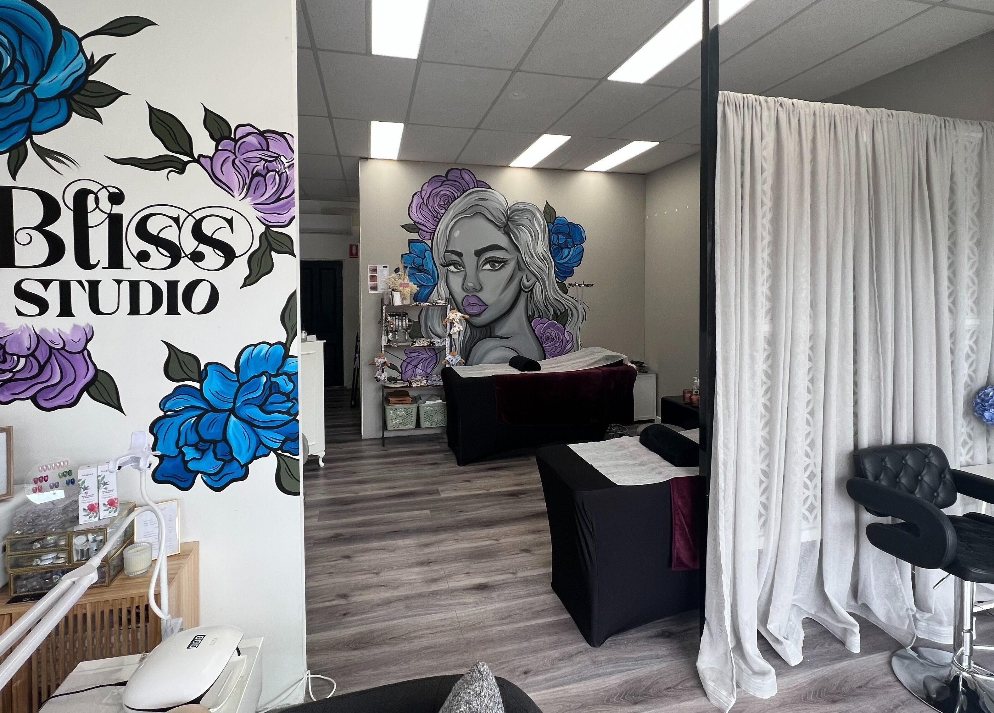 Interior of Bliss Lashes and Brows in Melbourne, Victoria, AU featuring vibrant wall art and modern decor.