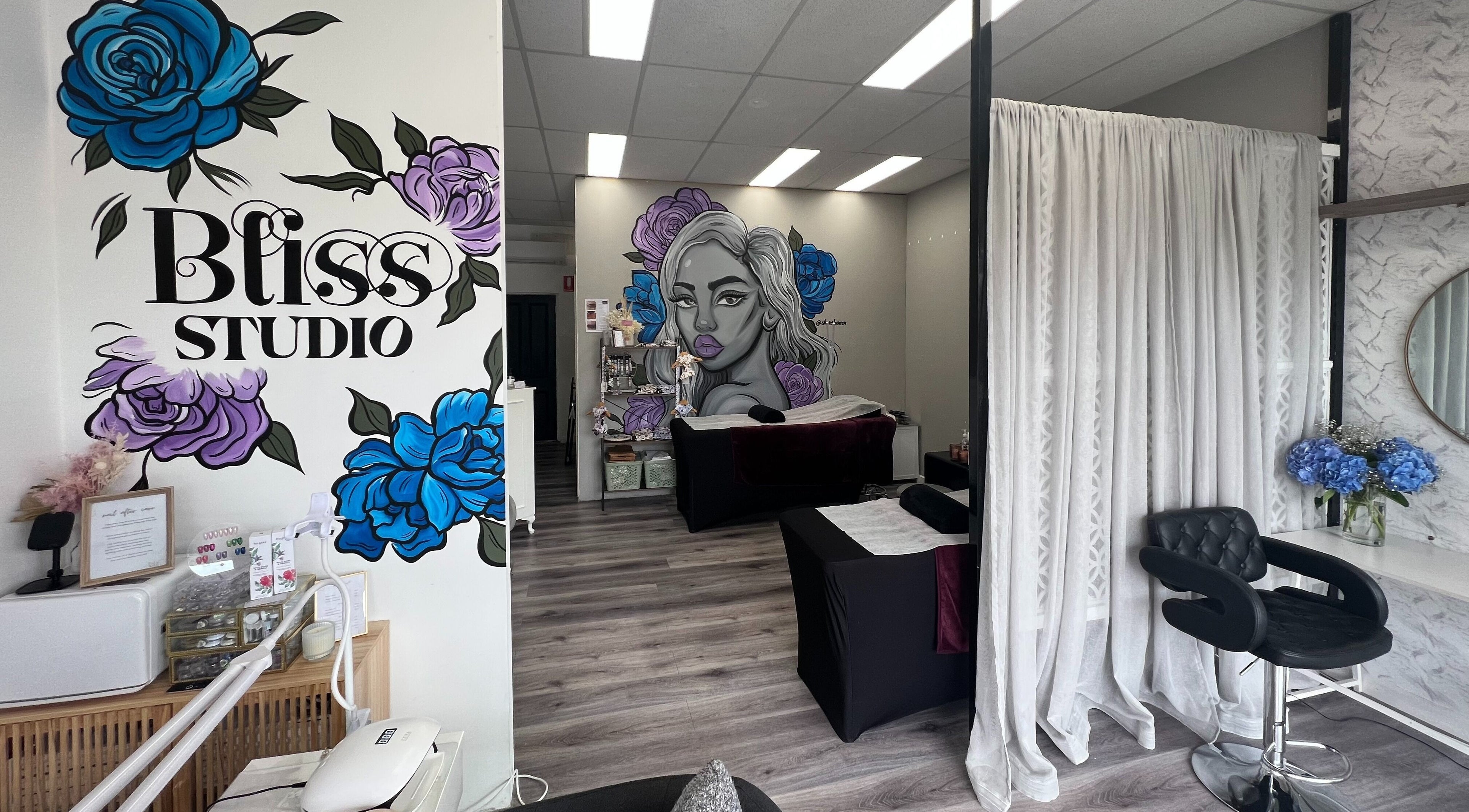 Interior of Bliss Lashes and Brows in Melbourne, Victoria, AU featuring vibrant wall art and modern decor.