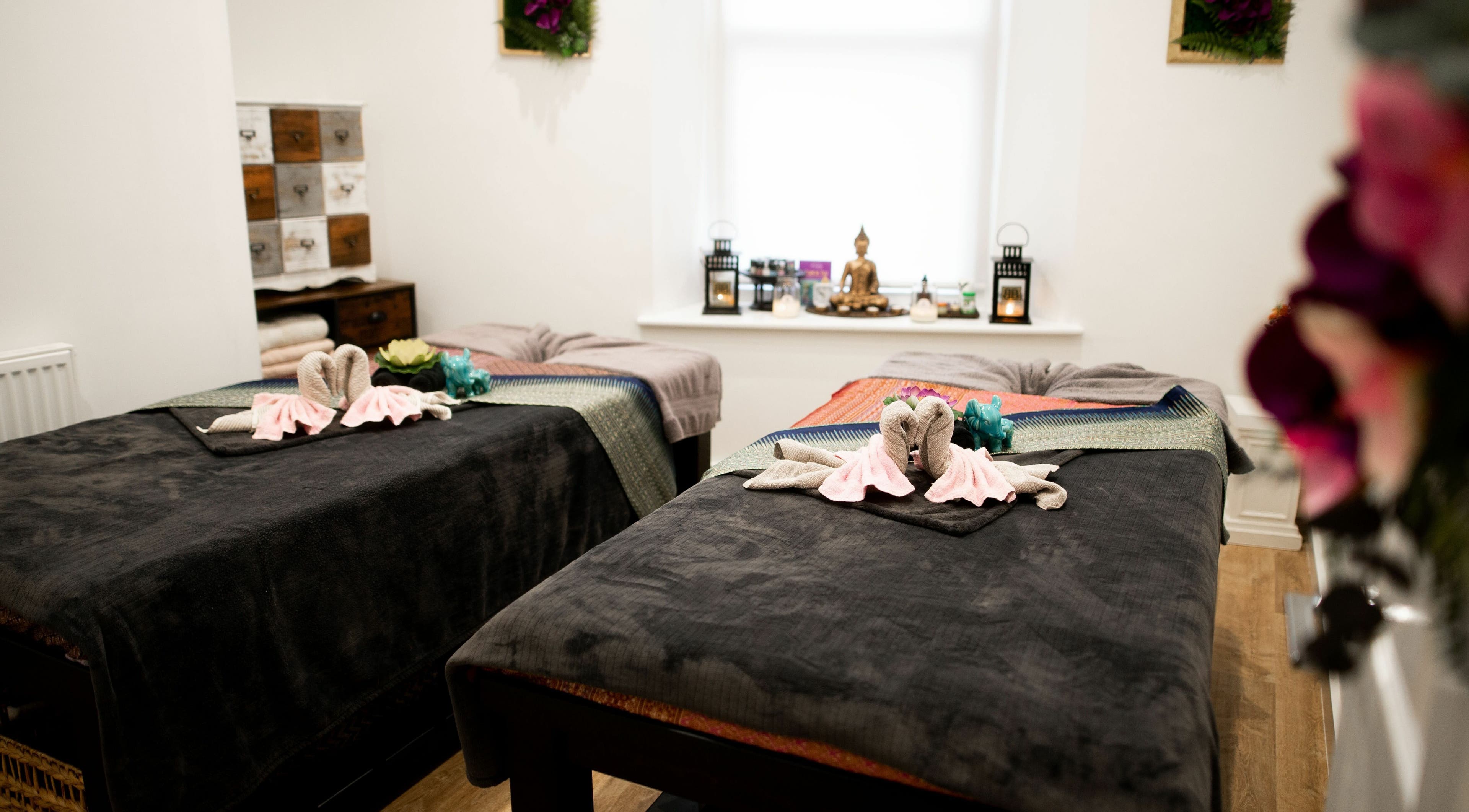 Tranquil massage room at Beauty Box, Penarth, Wales, GB with twin beds and elegant decor.
