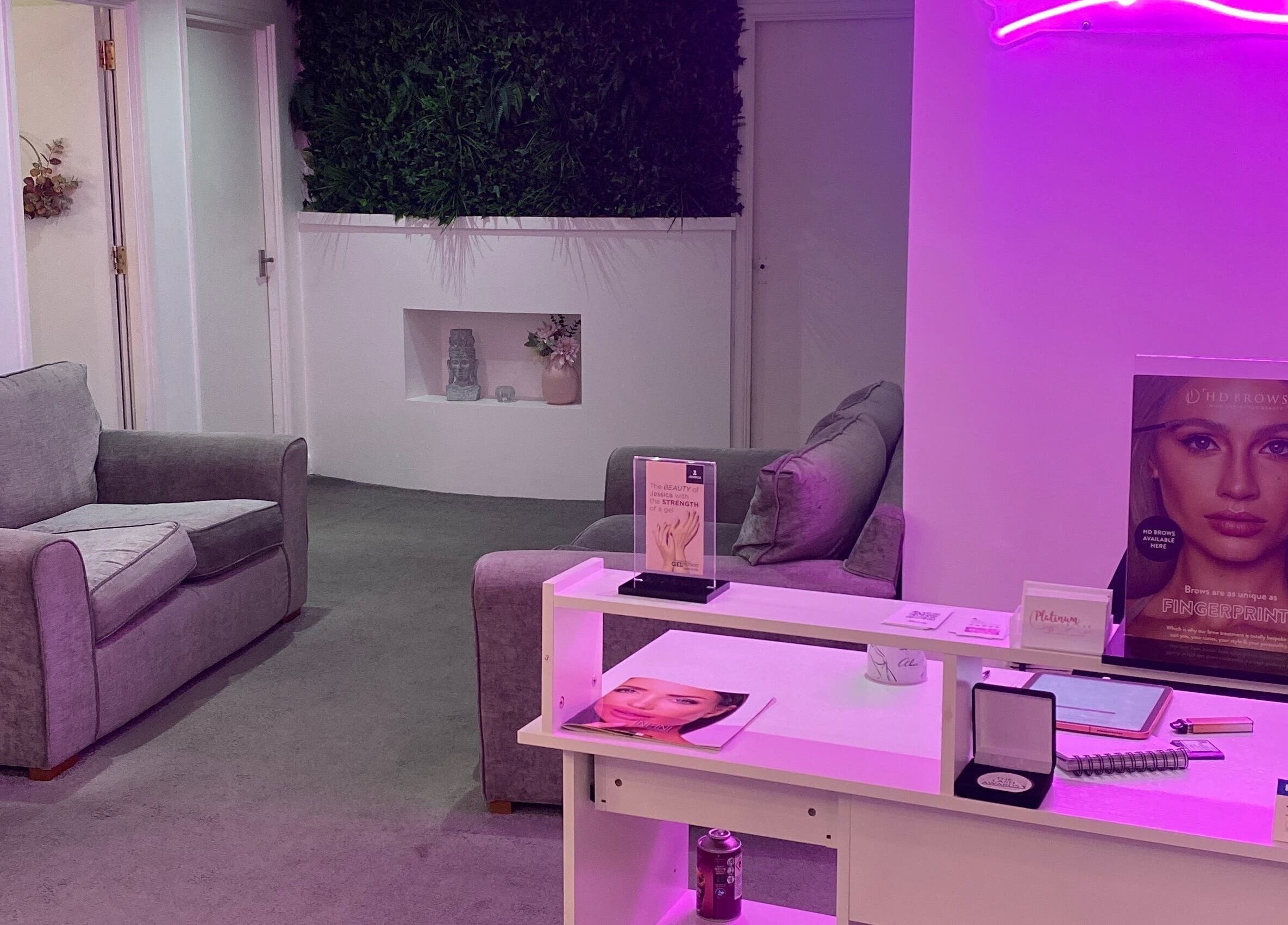 Cozy reception area of Platinum Brush Makeup and Beauty, Shepshed, England, GB, with sofas and elegant decor.