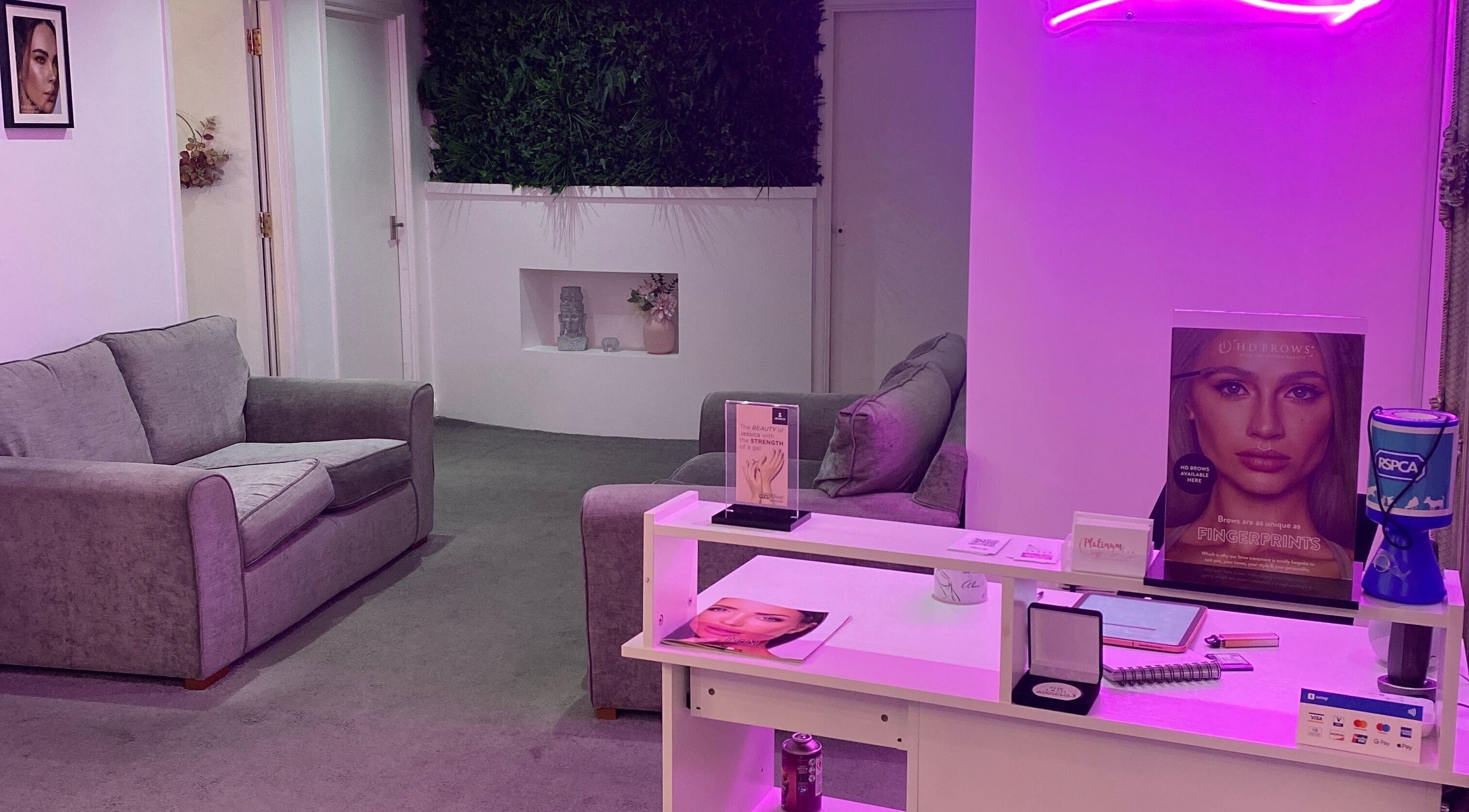 Cozy reception area of Platinum Brush Makeup and Beauty, Shepshed, England, GB, with sofas and elegant decor.