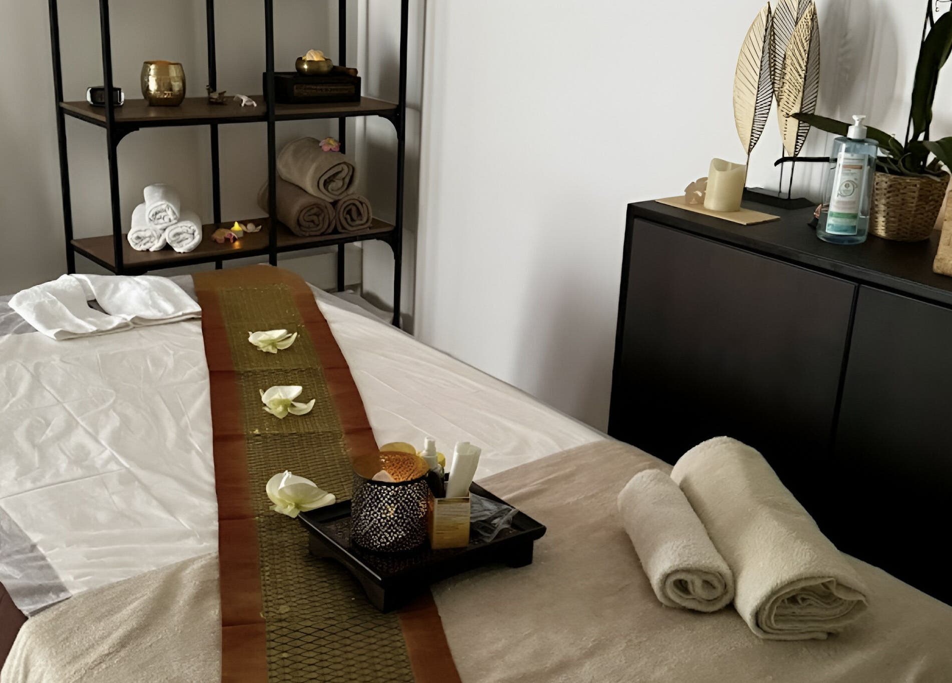 Table de massage paisible à Sao Zen Chessy, Chessy, Île-de-France, FR, avec serviettes pliées et décor raffiné.