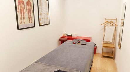 Tranquil massage room at Bangkok Sports Massage Thonglor, Wattana, Bangkok, TH, with a cozy bed and decor.