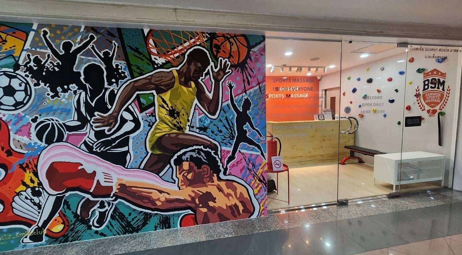 Vibrant mural at Bangkok Sports Massage Ari in Phaya Thai, Krung Thep Maha Nakhon, TH. Entrance with colorful sports theme.