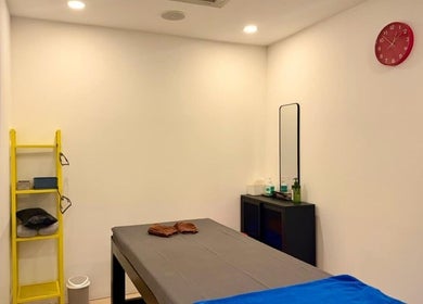 Relaxing treatment room at Bangkok Sports Massage Silom, Bangrak, Bangkok, TH, with massage table and wall decor.