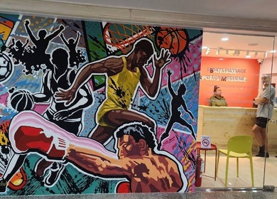 Colorful sports mural at Bangkok Sports Massage Silom, Bangrak, Bangkok, TH, near the vibrant reception area.