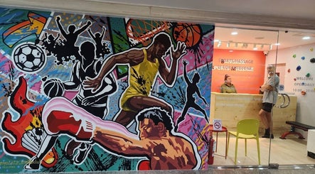 Colorful sports mural at Bangkok Sports Massage Silom, Bangrak, Bangkok, TH, near the vibrant reception area.