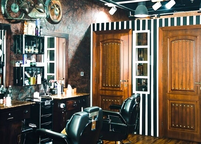 Elegant salon interior at Le Mirage, Doha, Doha Municipality, QA, featuring modern decor and professional styling chairs.