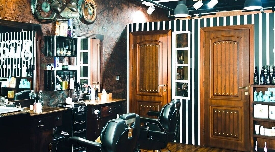 Elegant salon interior at Le Mirage, Doha, Doha Municipality, QA, featuring modern decor and professional styling chairs.