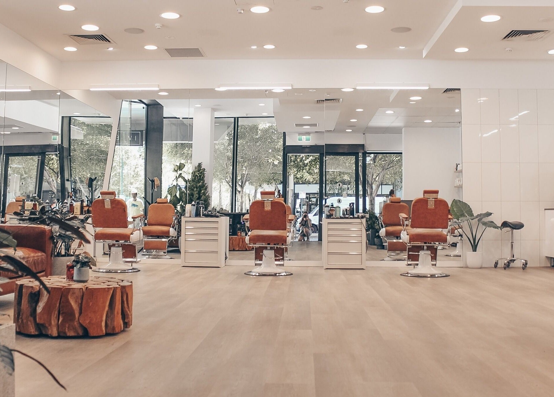 Modern barber chairs at IV Barbers, Melbourne, Victoria, AU, surrounded by stylish decor.