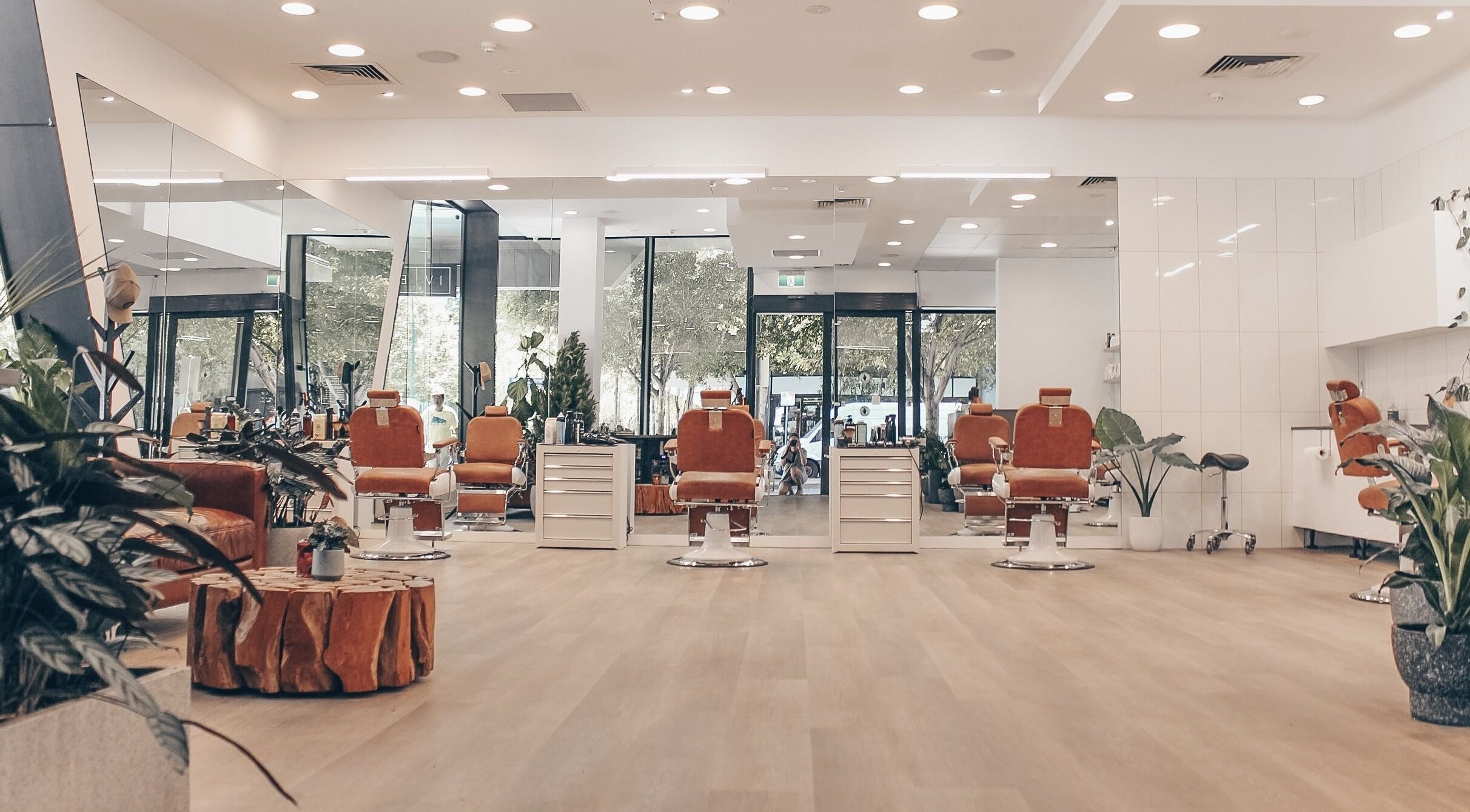 Modern barber chairs at IV Barbers, Melbourne, Victoria, AU, surrounded by stylish decor.