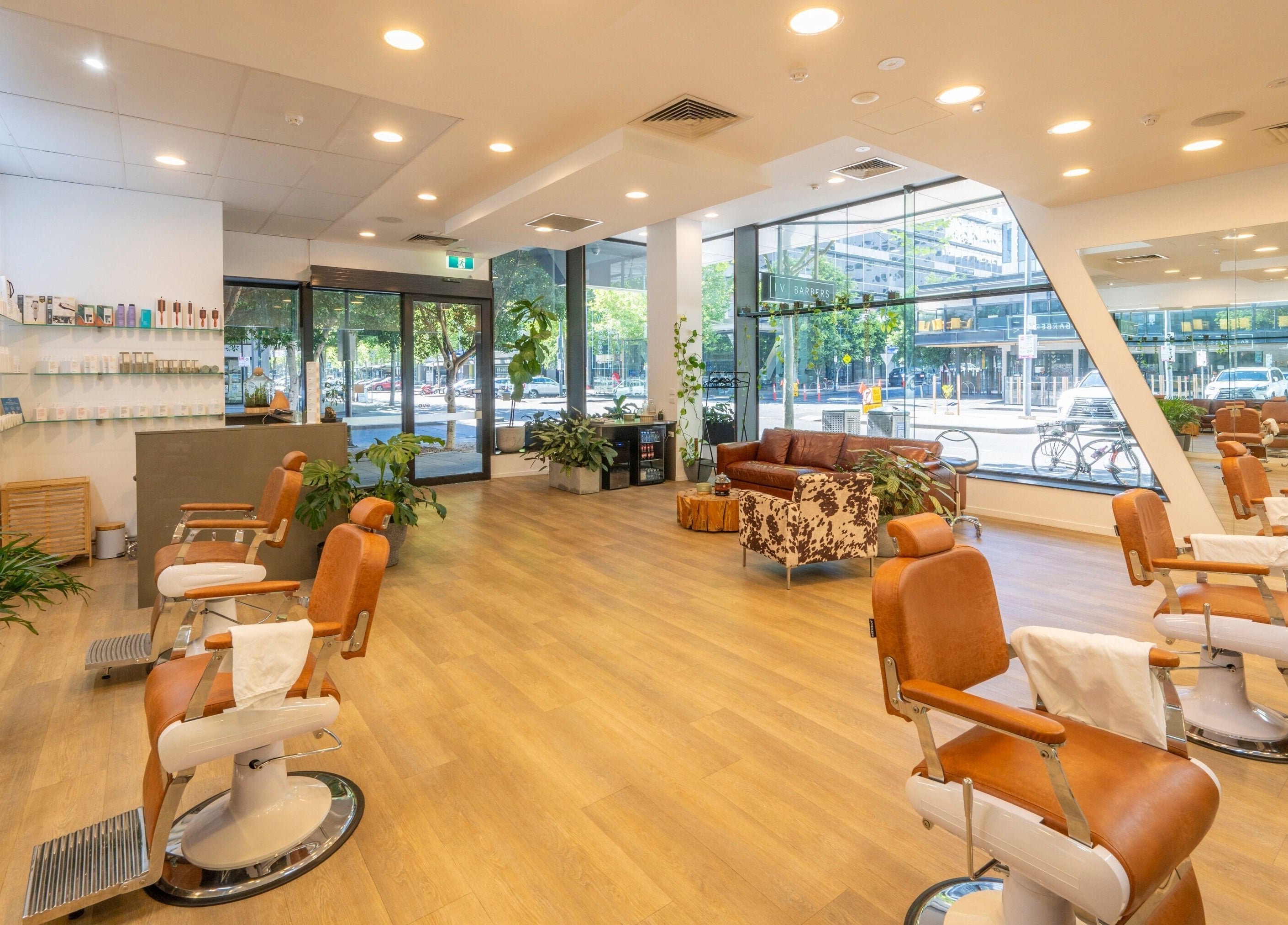 Sleek interiors of IV Barbers, Melbourne, Victoria, AU, featuring modern chairs and stylish decor.
