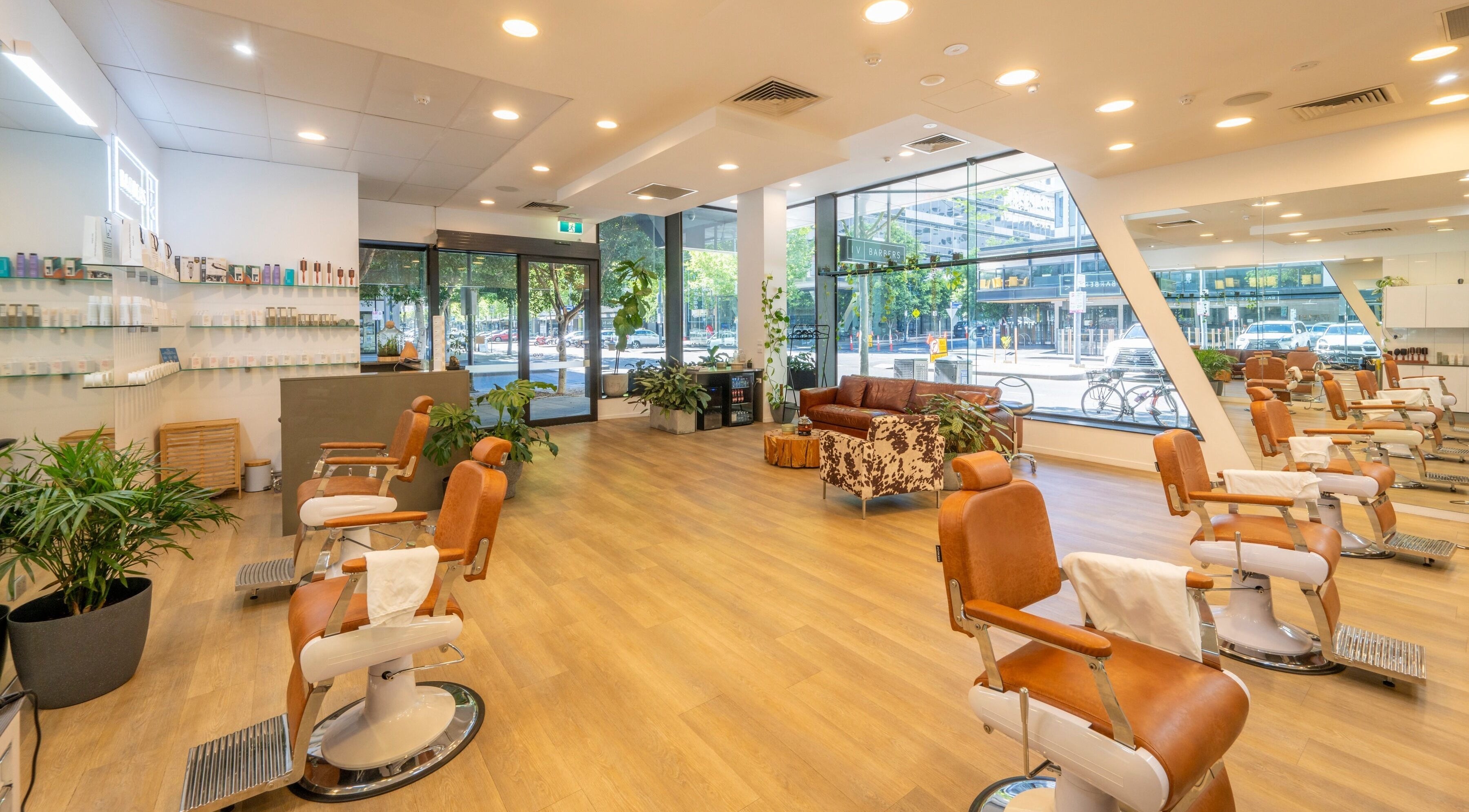 Sleek interiors of IV Barbers, Melbourne, Victoria, AU, featuring modern chairs and stylish decor.