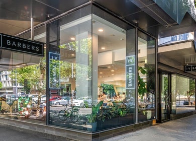 Front view of IV Barbers in Melbourne, Victoria, AU with glass windows and modern design.